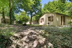 a house with a dirt yard in front of it at 17.Les Etoiles option Clim- 7 pers in Calviac
