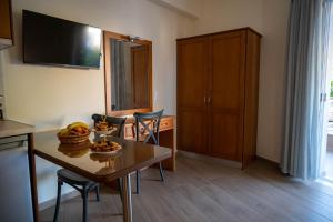 a kitchen with a table with a bowl of fruit on it at TRIANTAFYLLOY ROOMS in Loutra Edipsou