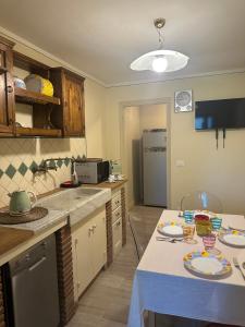 a kitchen with a table with plates on it at Spacious e Modern Comfort Near Center in Lucca