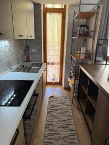 a kitchen with a sink and a counter top at Sa Domitta due Alghero in Alghero +5 photos