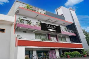 a white building with a black sign on it at Super Collection O NIT More Adityapur Formerly Hotel Subheksha in Jamshedpur