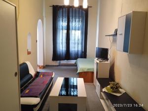 a small living room with a couch and a window at Mary in Cheb