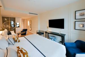 a hotel room with a bed and a tv at Sercotel Sevilla Don Luciano in Seville +83 photos