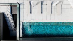a swimming pool in the side of a building at Sercotel Sevilla Don Luciano in Seville