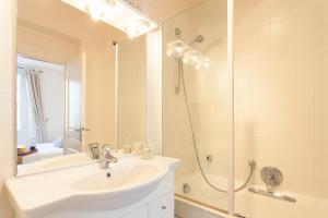 a white bathroom with a sink and a shower at Pimms Apartment in Antibes +27 photos