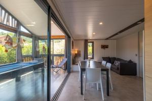 a dining room and living room with a pool table at Chalet L'entékia - Billard et Spa in Corcieux +23 photos
