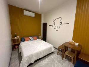 a bedroom with a bed and a drawing on the wall at V house 1 in Ban Huai Yai +9 photos