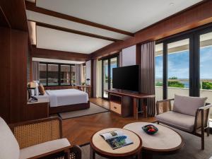 a hotel room with a bed and a television at Bali Beach Hotel in Sanur