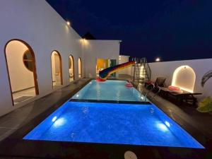 a swimming pool with a water slide in a house at V house 1 in Ban Huai Yai