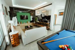 a living room with a pool table and a couch at V house 1 in Ban Huai Yai