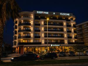 a building with cars parked in front of it at Grand Clochē in Ulcinj