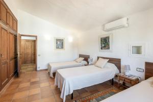 a hotel room with two beds and a table at Apartamento I Els Cucons in Sant Pere de Ribes +19 photos