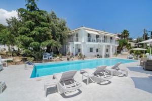 a villa with a swimming pool and a house at Xenia & Antonis in Nikiana