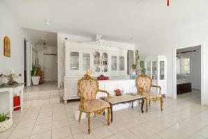 a living room with a table and chairs and a kitchen at Xenia & Antonis in Nikiana