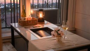 a table with a bottle of wine and a glass at Gapyeong Ribbon Spa Pool Villa in Gapyeong +2 photos