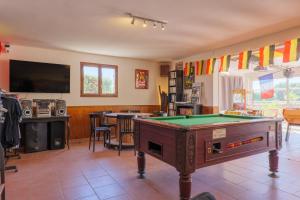 a living room with a pool table and a tv at Le Peuplier - La Fontinelle in Bessas