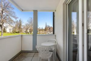a balcony with a table and chairs and a window at Apartment 44 in Bad Dürrheim
