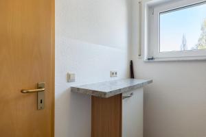 a kitchen with a counter and a window at Apartment 44 in Bad Dürrheim +11 photos