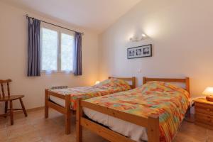 a bedroom with a bed and a window at Le Micocoulier - La Fontinelle in Bessas +21 photos
