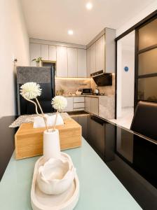 a kitchen with a vase with flowers on a table at Noble Cove Batam in Pulau Sembakau Kecil