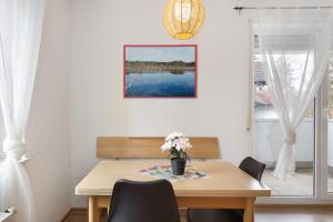 a dining room table with a vase of flowers on it at Apartment 45 in Bad Dürrheim