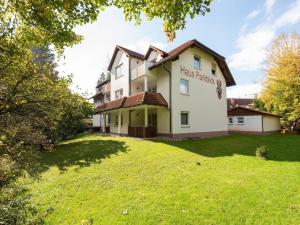 a house with a green lawn in front of it at Apartment 45 in Bad Dürrheim