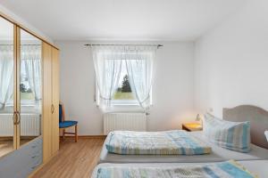 a bedroom with two beds and a window at Apartment 47 in Bad Dürrheim +19 photos