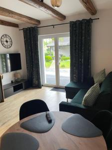 a living room with a couch and a table at Agroturystyka u Iwony in Wiekowo