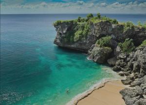 an aerial view of a beach next to the ocean at White Palm Uluwatu - Wellness & Recovery Retreat - 2 Min Walk to Balangan Beach in Jimbaran