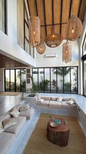 a large living room with white couches and a table at Kilimanjaro Haven Villas in Shiri