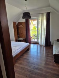 a bedroom with a bed and a large window at Relax Penzion U Adama in Dolná Tižina +88 photos