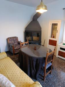 a living room with a table and a fireplace at Alojamiento Rural La Granja in La Cerradura