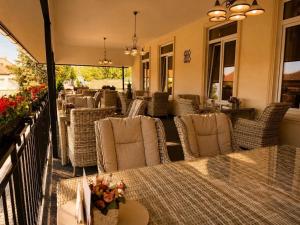 a restaurant with tables and chairs on a patio at Hotel ZÁMOCKÁ KORUNA u Hoffera in Nitra