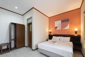 a bedroom with a large bed in a room at Cove Rumah Asri in Bandung +13 photos