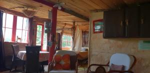 a room with chairs and a table and windows at Cabane Layénie sous les étoiles in Bajamont