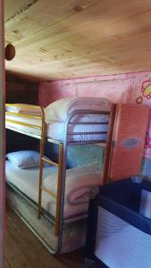 a couple of bunk beds in a room at Cabane Layénie sous les étoiles in Bajamont