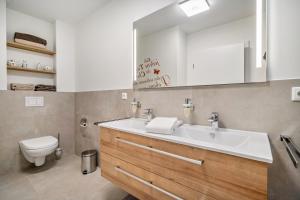 a bathroom with a sink and a toilet at Haus am See in Malchow +76 photos