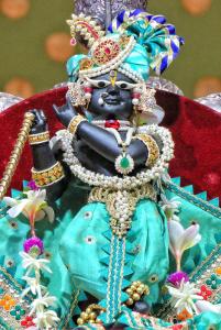 a cake with a statue of a god with jewels at Hotel Kanta Kuteer Barsana in Barsāna +1 photo