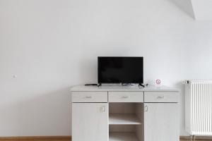 a white cabinet with a television on top of it at Apartment 36 in Bad Dürrheim