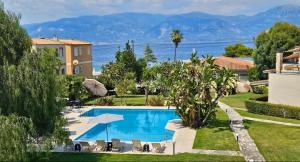 a swimming pool in a villa with a view of the ocean at Megusta Apartments Selianitika - Poolside Escape in Selianitika