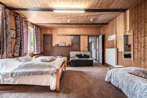 a bedroom with two beds and a couch in it at Maison De La Coutettaz in Morzine