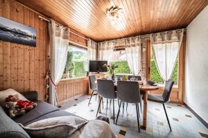 a living room with a table and chairs and a couch at Le petit Chalet in Morzine