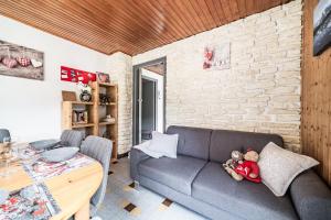 two teddy bears sitting on a couch in a living room at Le petit Chalet in Morzine
