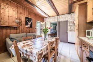 a dining room with a table and a couch at Maison De La Coutettaz in Morzine