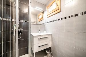 a bathroom with a sink and a shower at Le petit Chalet in Morzine +15 photos