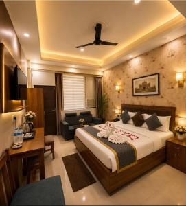 a hotel room with a bed and a desk at Frolic Hotel Near Sec 52 Noida Metro Station in Noida +74 photos