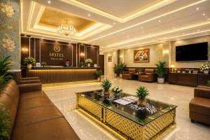 a hotel lobby with a couch and a table at Hotel Decent Premier Suites Near Delhi Aerocity in New Delhi