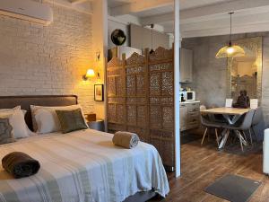 a bedroom with a bed and a kitchen and a table at Il Saraceno B&B in Carovigno +82 photos