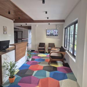 a living room with a colorful carpet at Windowind Resort in Koroth