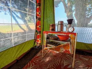 a inside of a tent with a table in it at une nuit insolite en 1980 in Crédin